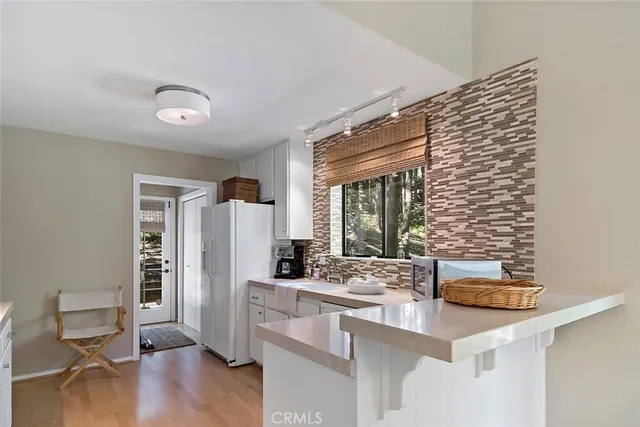 a kitchen with stainless steel appliances kitchen island granite countertop a refrigerator and a stove