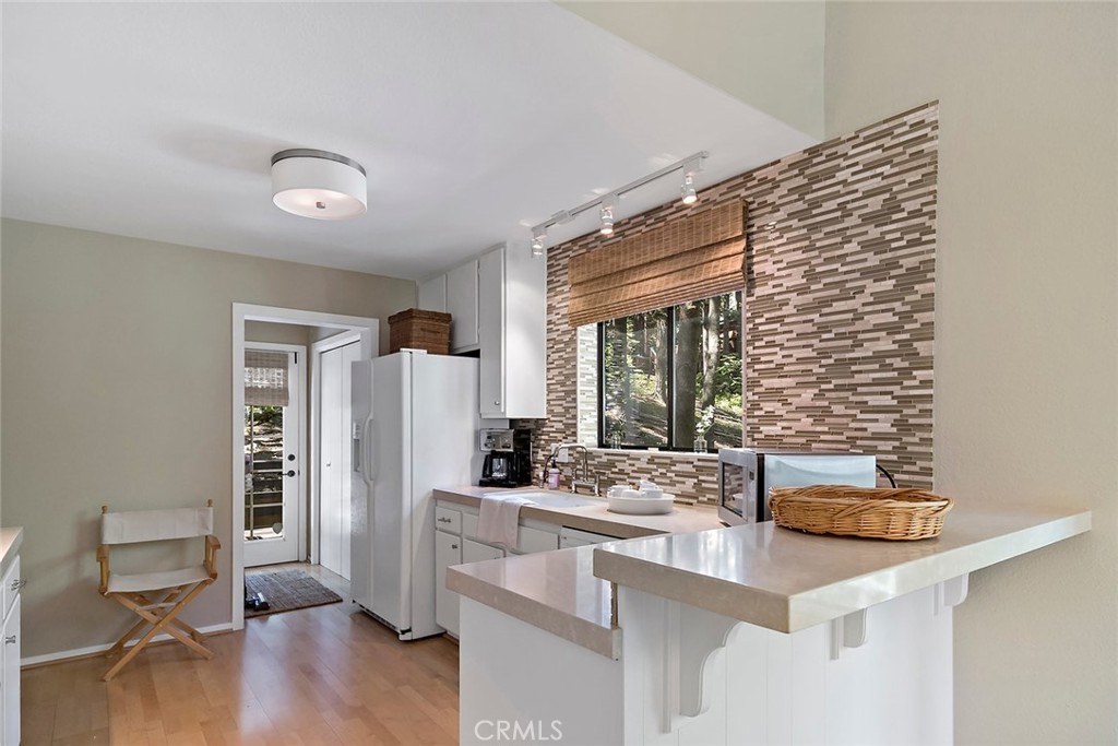 612 Karenken Pines Drive Lake Arrowhead, CA 92391 - Photo 15 of 44 a kitchen with stainless steel appliances kitchen island granite countertop a refrigerator and a stove