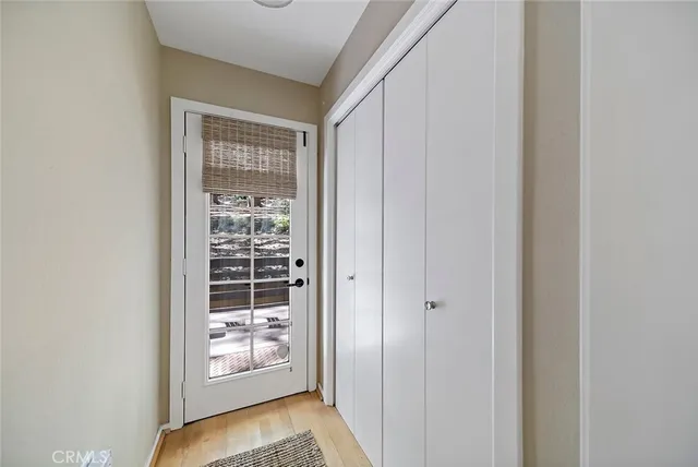 a view of an entryway with wooden floor