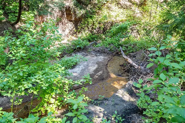 a backyard of a house with a yard and outdoor seating