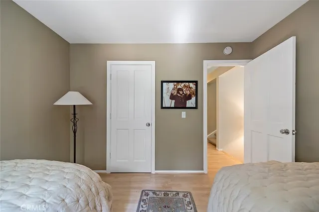 a bedroom with a bed and a lamp