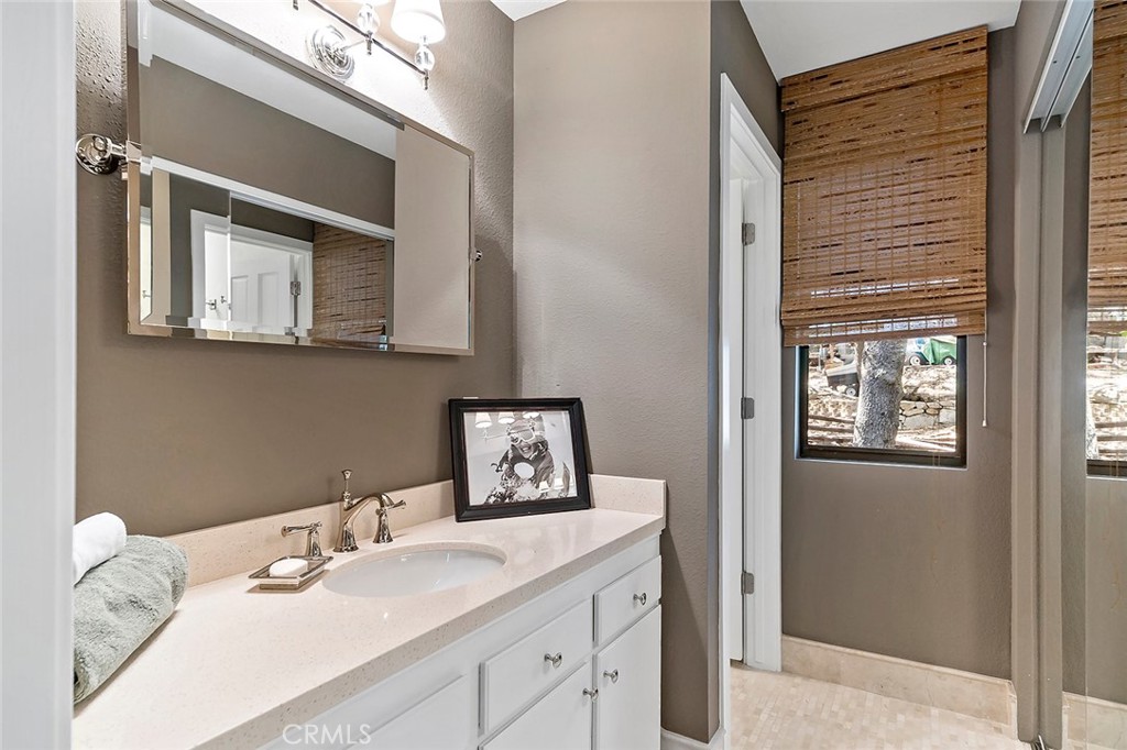 612 Karenken Pines Drive Lake Arrowhead, CA 92391 - Photo 25 of 44 a bathroom with a sink and a mirror