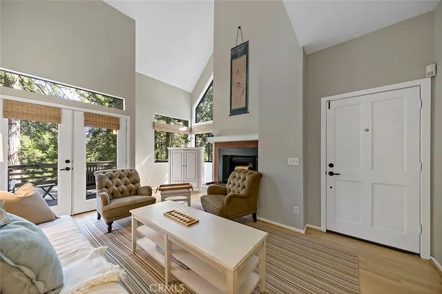 a living room with furniture a large window and a fireplace