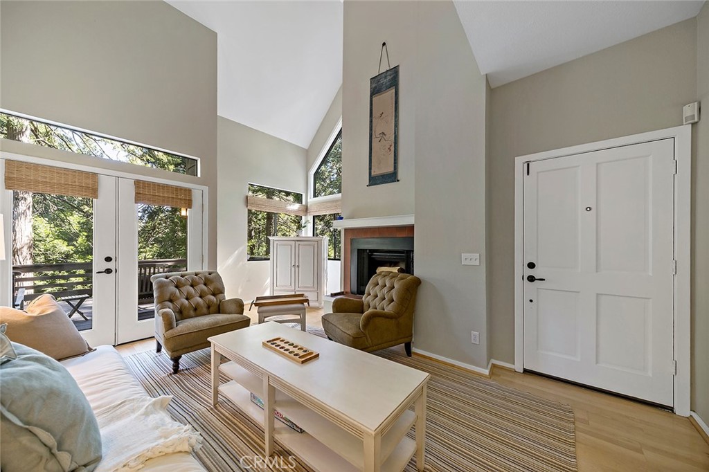 612 Karenken Pines Drive Lake Arrowhead, CA 92391 - Photo 9 of 44 a living room with furniture a large window and a fireplace