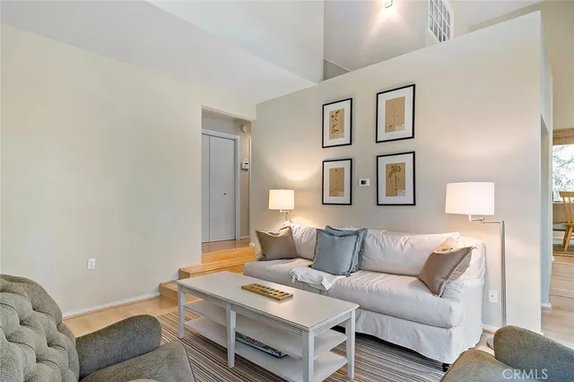 a living room with furniture and a night stand