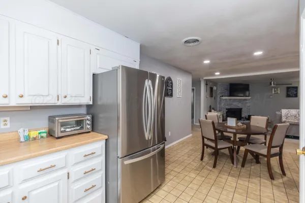 a kitchen with stainless steel appliances granite countertop a refrigerator and a stove top oven
