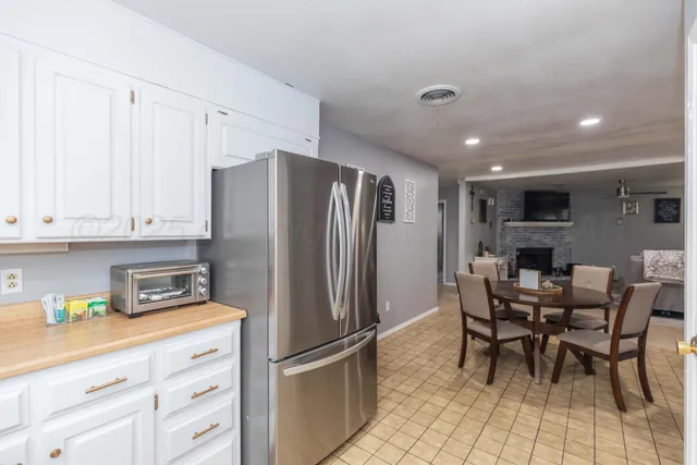 a kitchen with stainless steel appliances granite countertop a refrigerator and a stove top oven