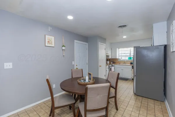 a kitchen with a table and chairs