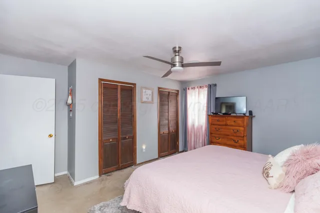 a bedroom with a bed and a television