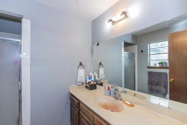a bathroom with a sink vanity and a mirror