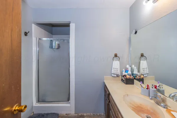 a bathroom with a sink vanity and a mirror