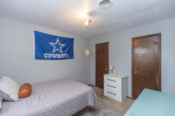 a bedroom with a bed and a lamp