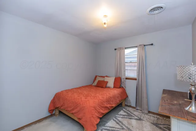 a bedroom with a bed and window