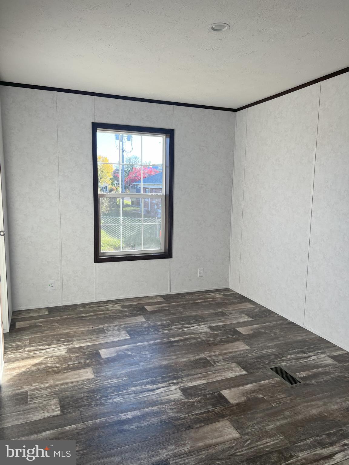 211 Eisenhower Road Moorefield, WV 26836 - Photo 11 of 17 a view of an empty room with window and hardwood floor