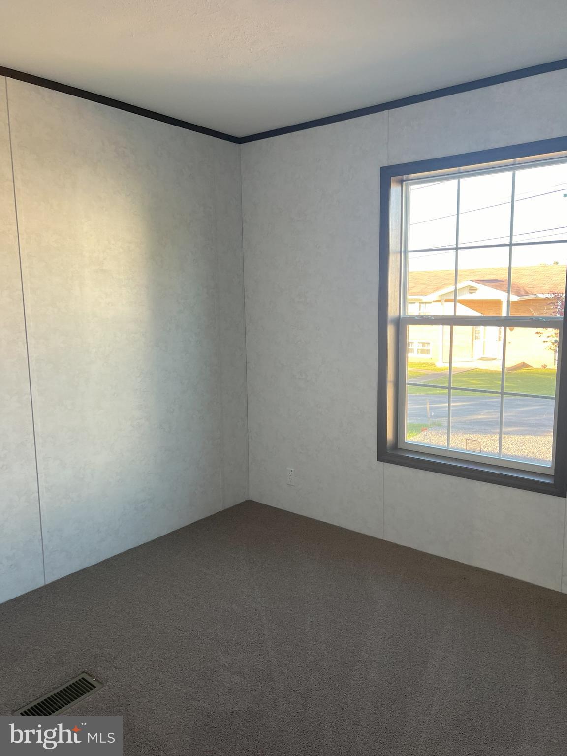 211 Eisenhower Road Moorefield, WV 26836 - Photo 13 of 17 an empty room with a window