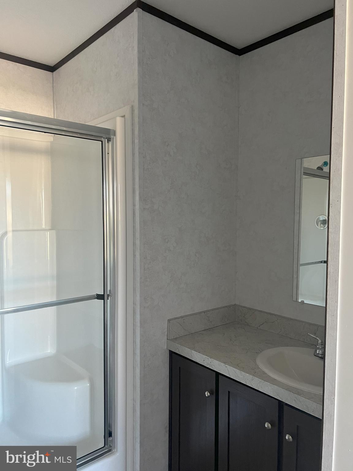 211 Eisenhower Road Moorefield, WV 26836 - Photo 6 of 17 a bathroom with a granite countertop sink and a mirror