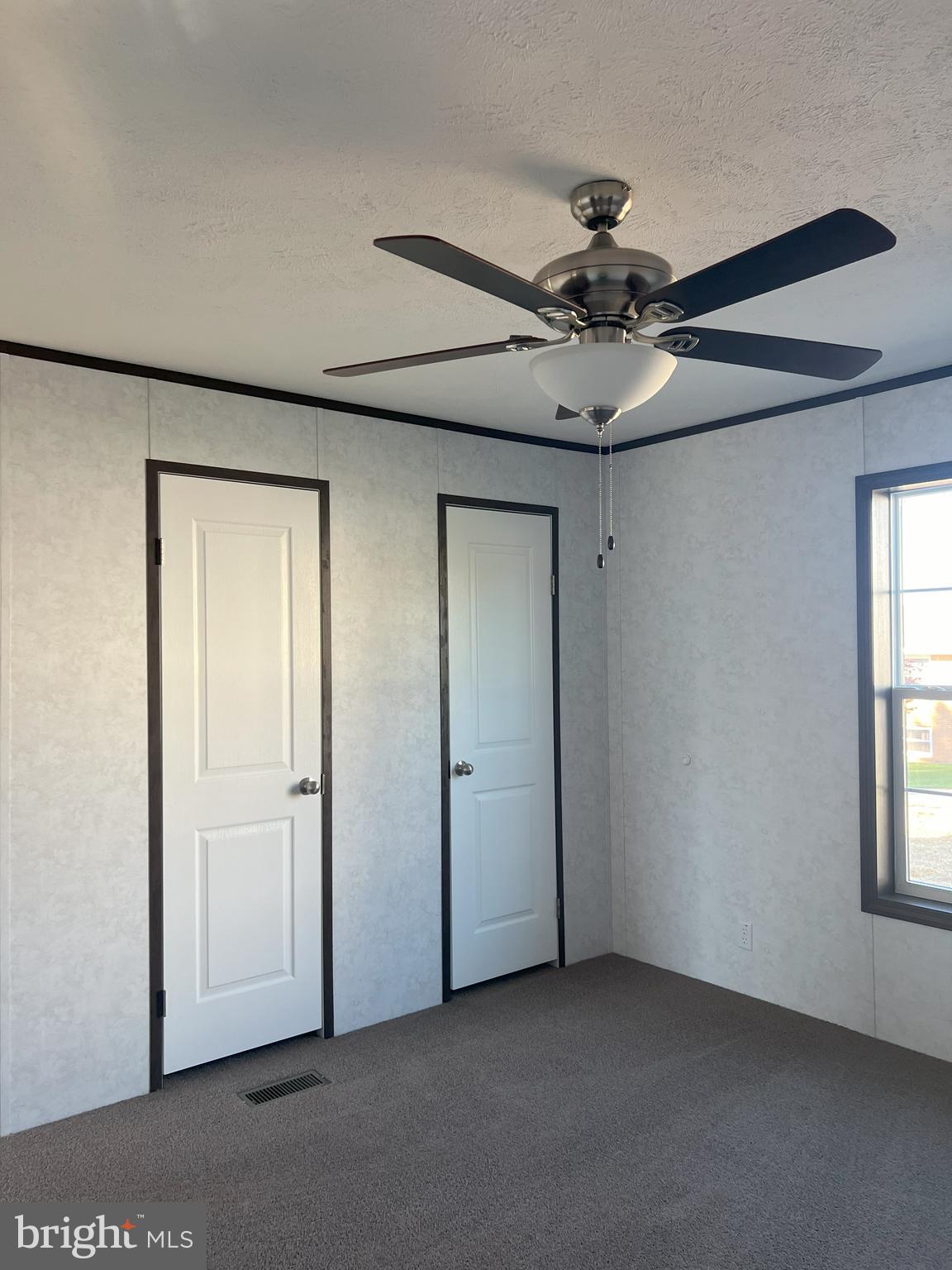211 Eisenhower Road Moorefield, WV 26836 - Photo 7 of 17 a view of a livingroom with a ceiling fan and window