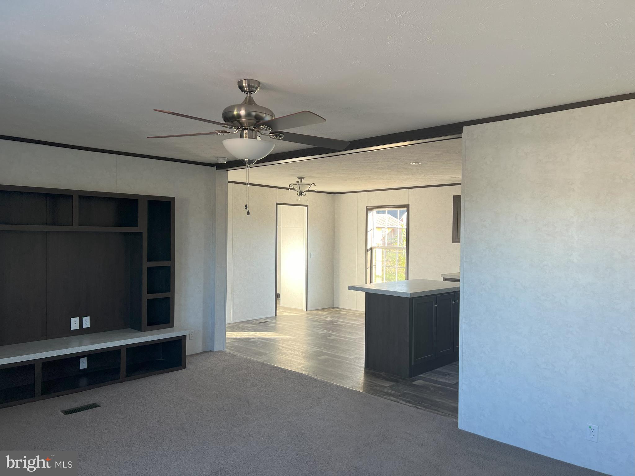 211 Eisenhower Road Moorefield, WV 26836 - Photo 8 of 17 a view of an empty room with a kitchen