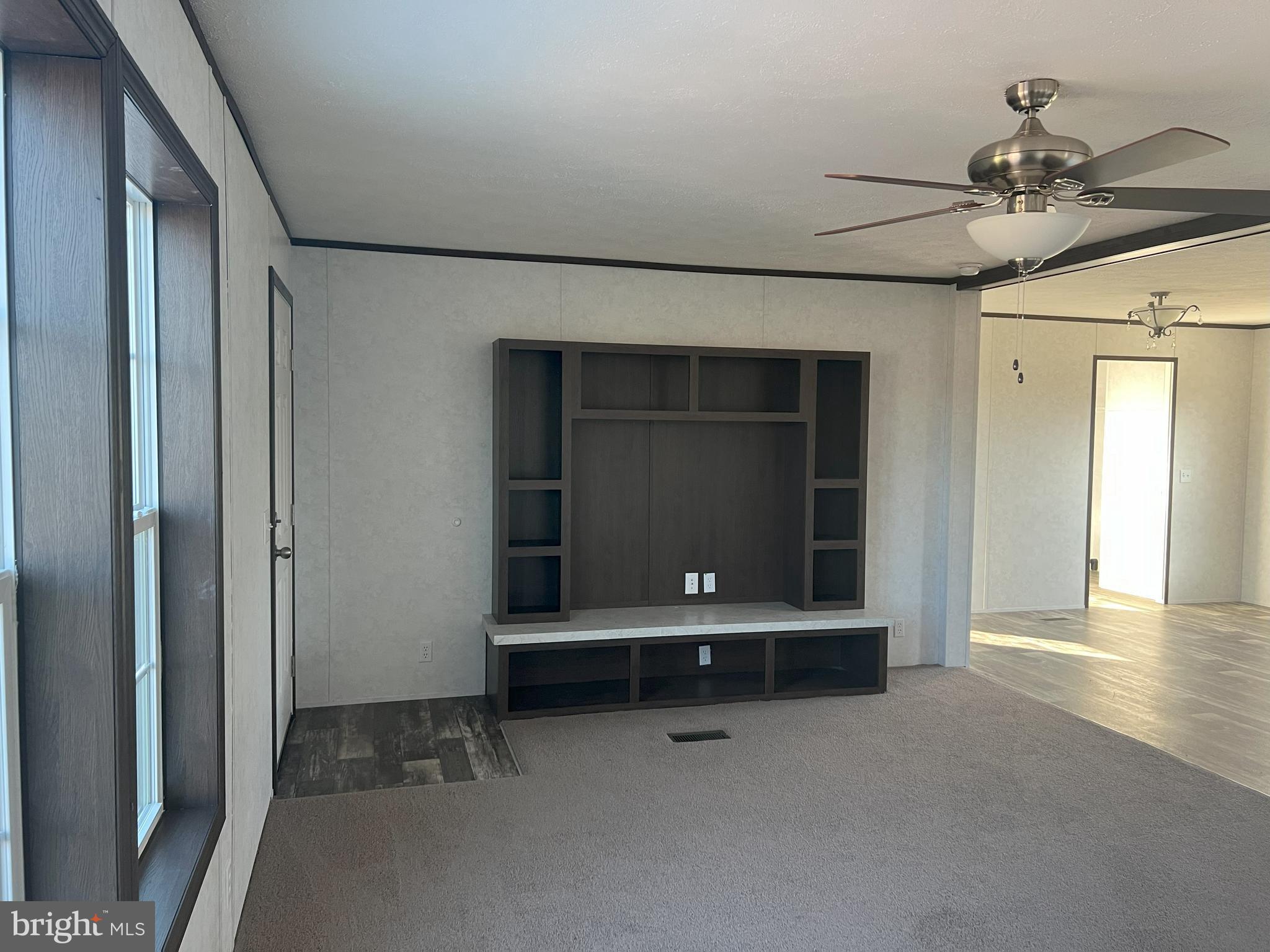 211 Eisenhower Road Moorefield, WV 26836 - Photo 9 of 17 a view of room with wooden floor and fan