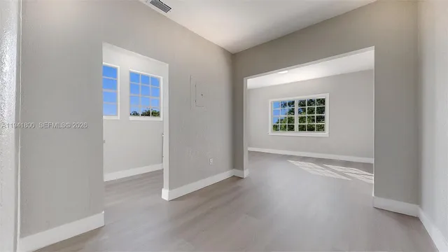 a view of room with window and hardwood floor