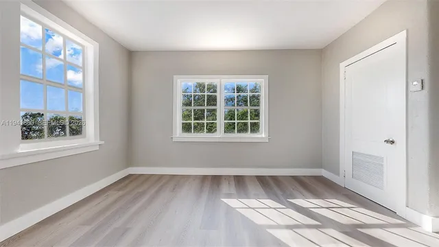 a living room with furniture a large window and a flat screen tv