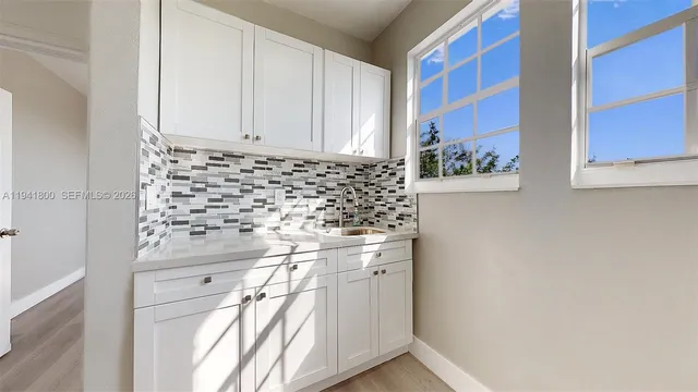 a kitchen with stainless steel appliances a sink stove and white refrigerator