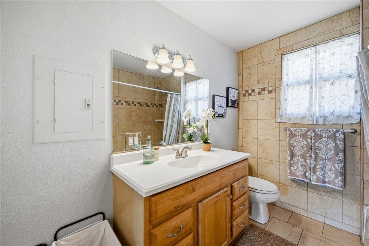 232 Upper Slate Creek Road Grass Valley, CA 95945 - Photo 21 of 48 a bathroom with a sink mirror and a toilet