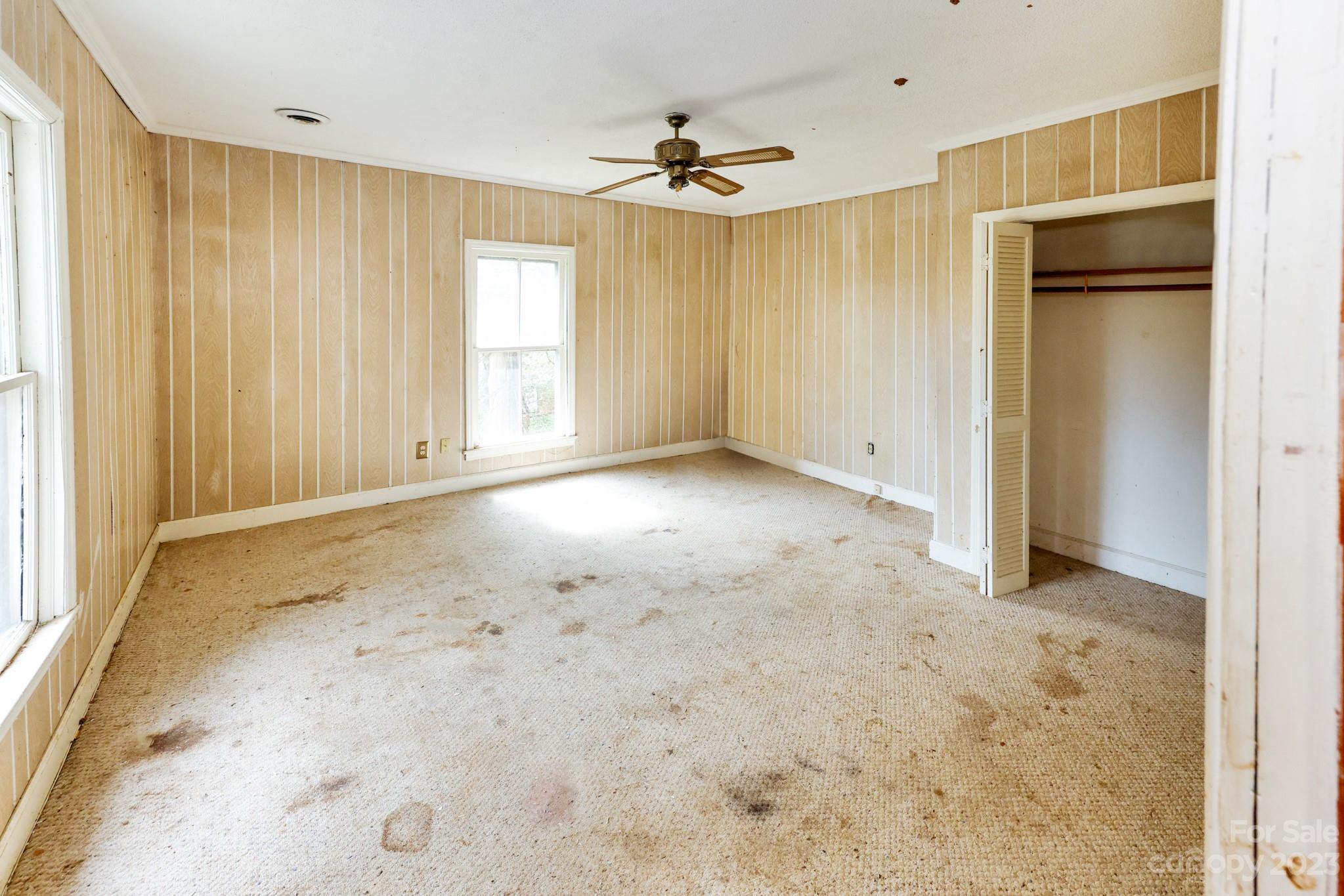 158 Pine Street Rutherfordton, NC 28139 - Photo 16 of 37 an empty room with a ceiling fan and window