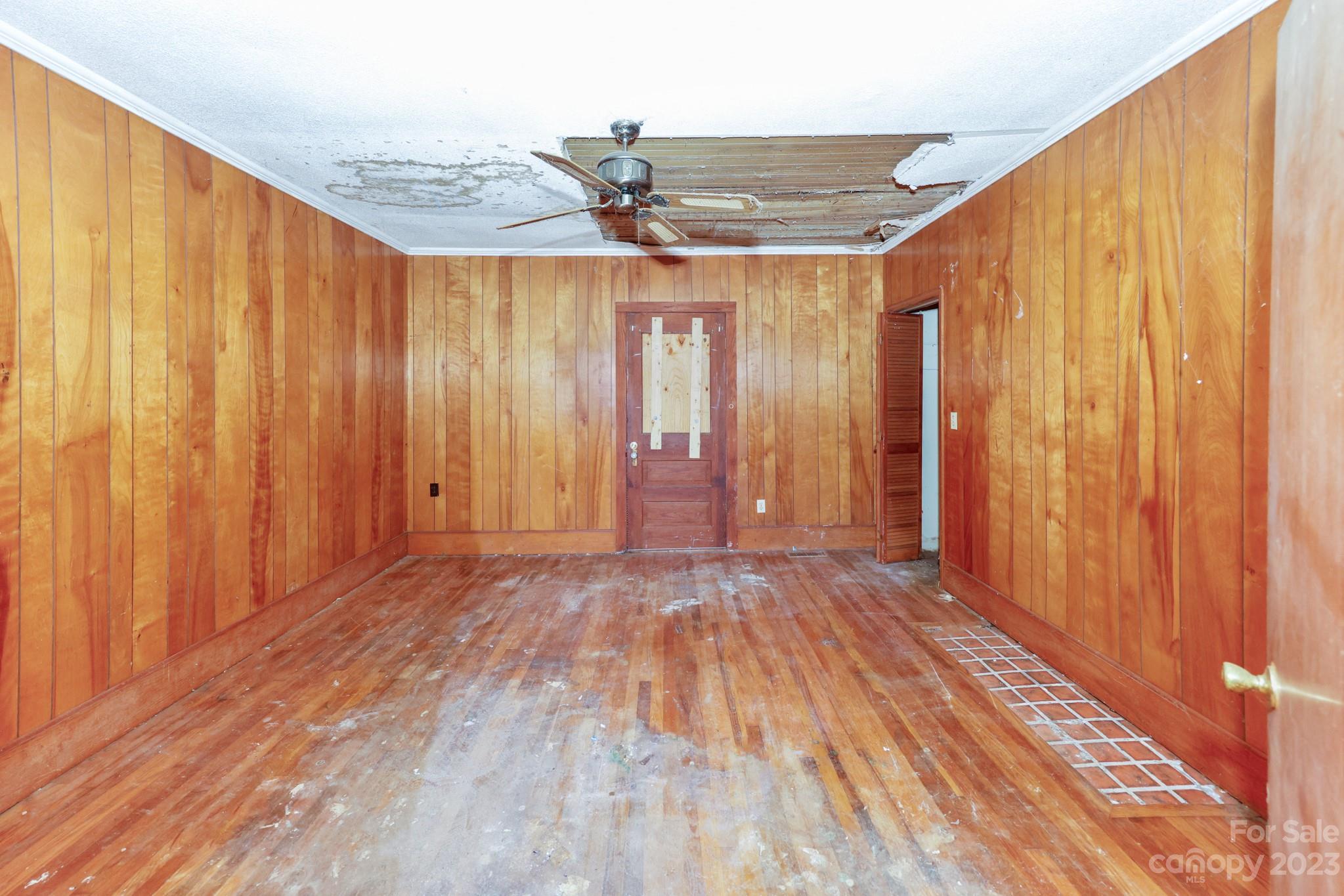 158 Pine Street Rutherfordton, NC 28139 - Photo 7 of 37 an empty room with wooden floor and windows