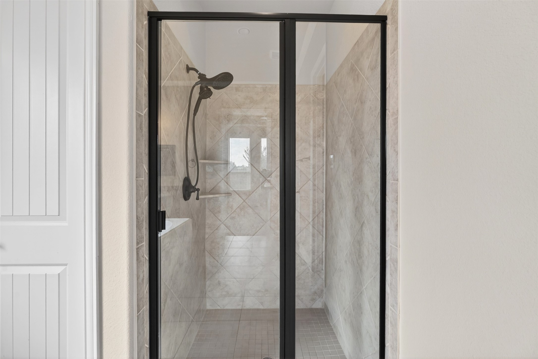 18202 Wedgewood Bluff Court Spring, TX 77379 - Photo 30 of 50 Separate primary shower with glass enclosure and neutral tile surround.