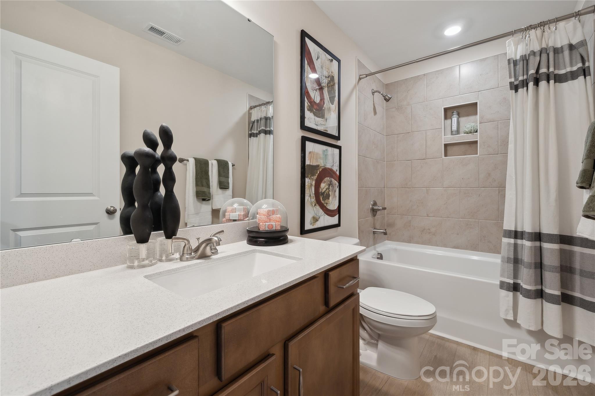 5857 Tuckaseegee Road, Unit 4 Charlotte, NC 28208 - Photo 12 of 23 a bathroom with a sink a toilet and shower