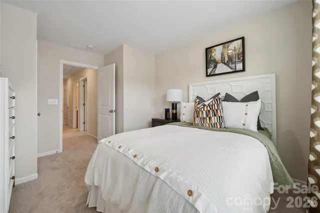 a large white bed in a white room