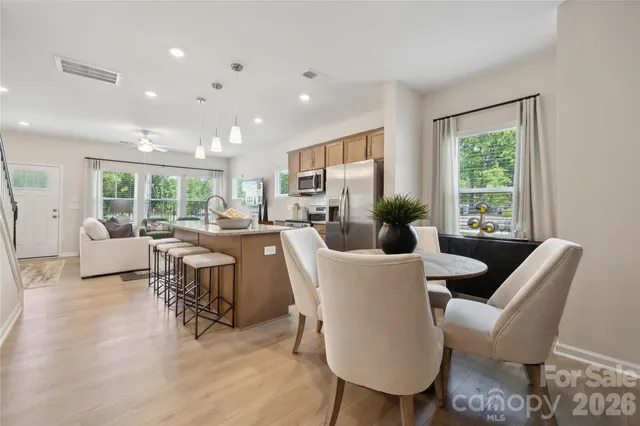a living room with furniture potted plant a window and a potted plant