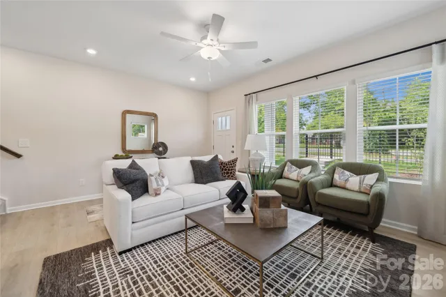 a living room with furniture and a large window
