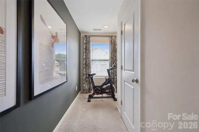 a view of a room with a lounge chair and windows