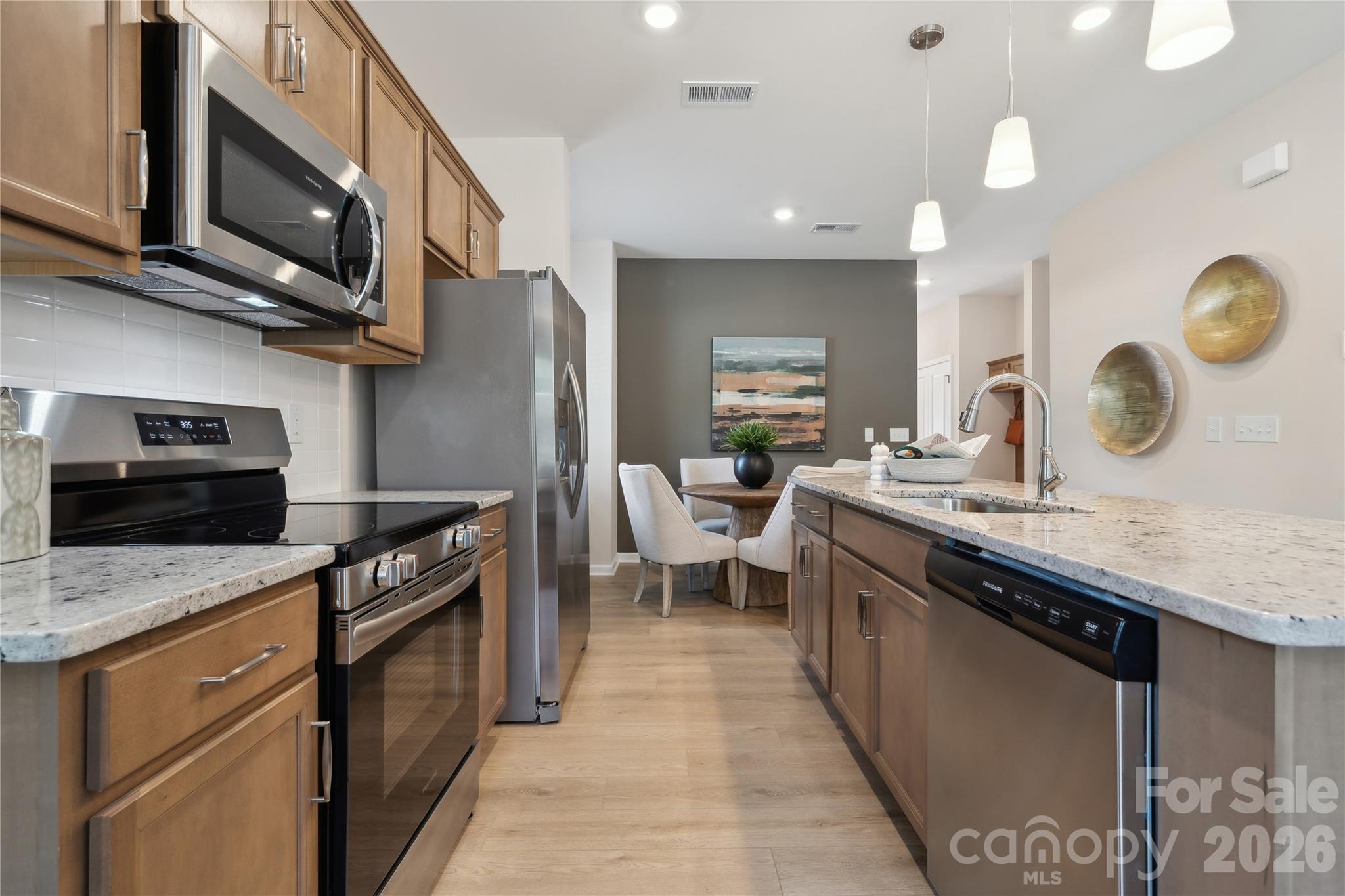 5857 Tuckaseegee Road, Unit 4 Charlotte, NC 28208 - Photo 3 of 23 a kitchen with stainless steel appliances granite countertop a sink a stove top oven and a refrigerator