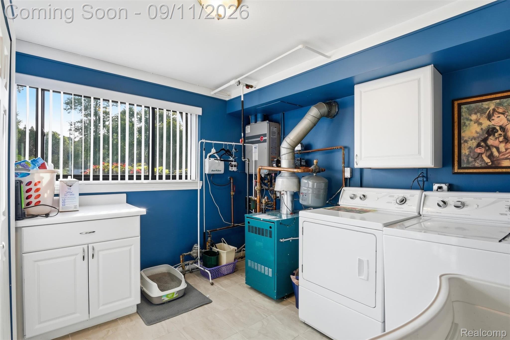 16799 Farmington Road Livonia, MI 48154 - Photo 39 of 71 Functional utility space with a window, white cabinetry, a laundry sink, and a washer and dryer