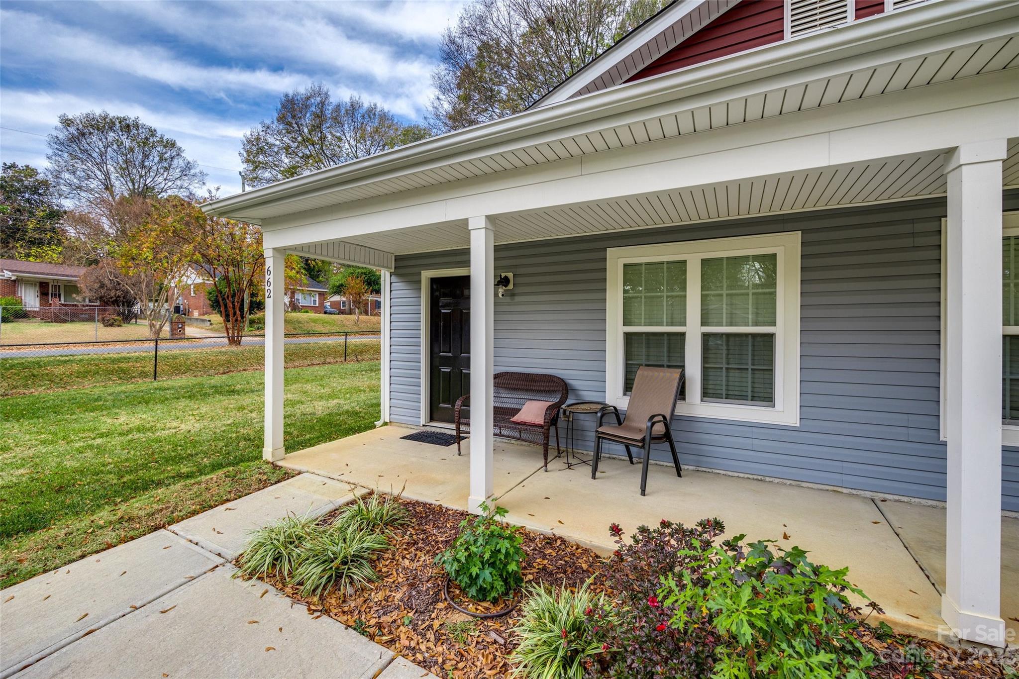662-664 Reeves Court Charlotte, NC 28208 - Photo 3 of 12 a view of a house with backyard sitting area and garden