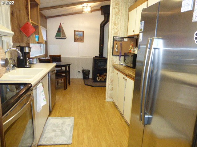 100 River Bend Road, Unit 2 Reedsport, OR 97467 - Photo 8 of 25 a kitchen with a sink appliances and cabinets