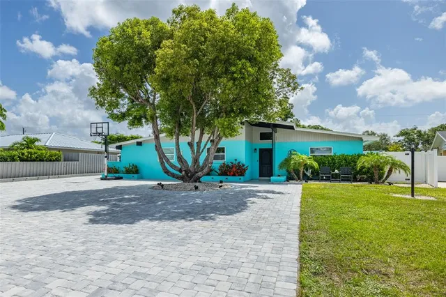 a front view of a house with a yard and a garage