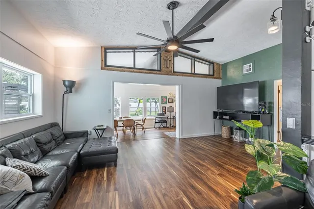 a living room with furniture and wooden floor