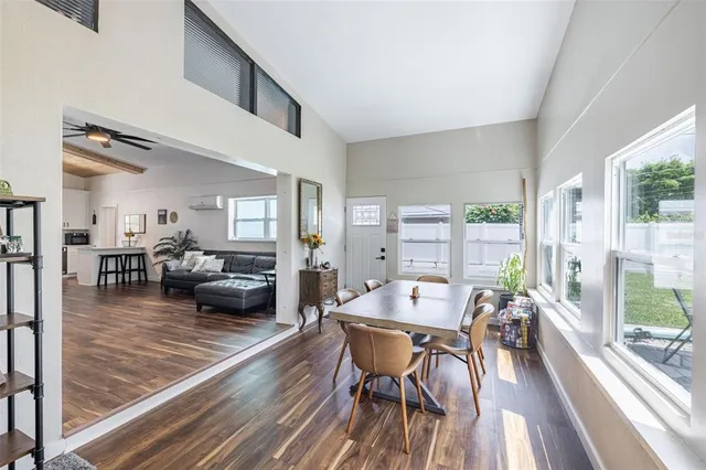 a dining room with furniture window and wooden floor