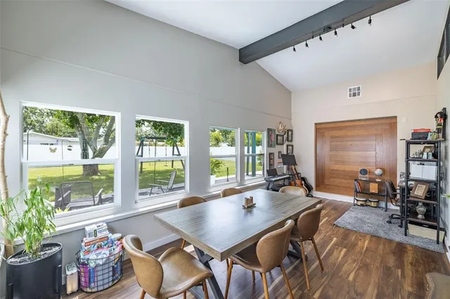 a bedroom with a bed and a wooden floor
