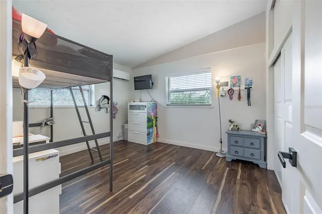 a empty room with wooden floor and furniture