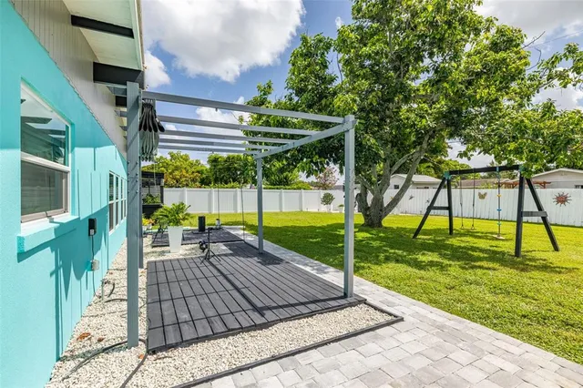 a view of a backyard with plants and a patio