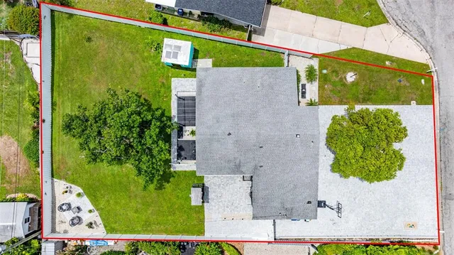 an aerial view of a house with a yard