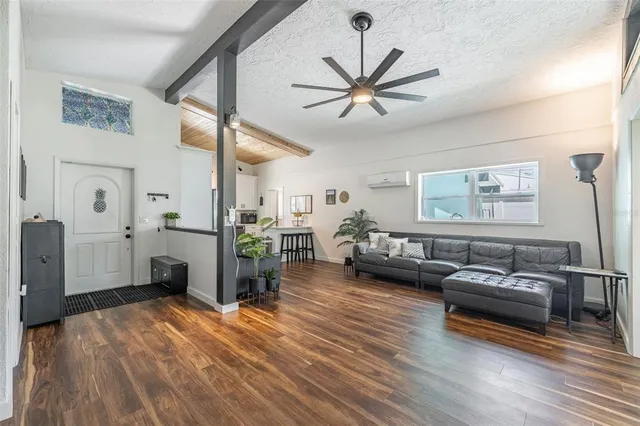 a living room with furniture and wooden floor