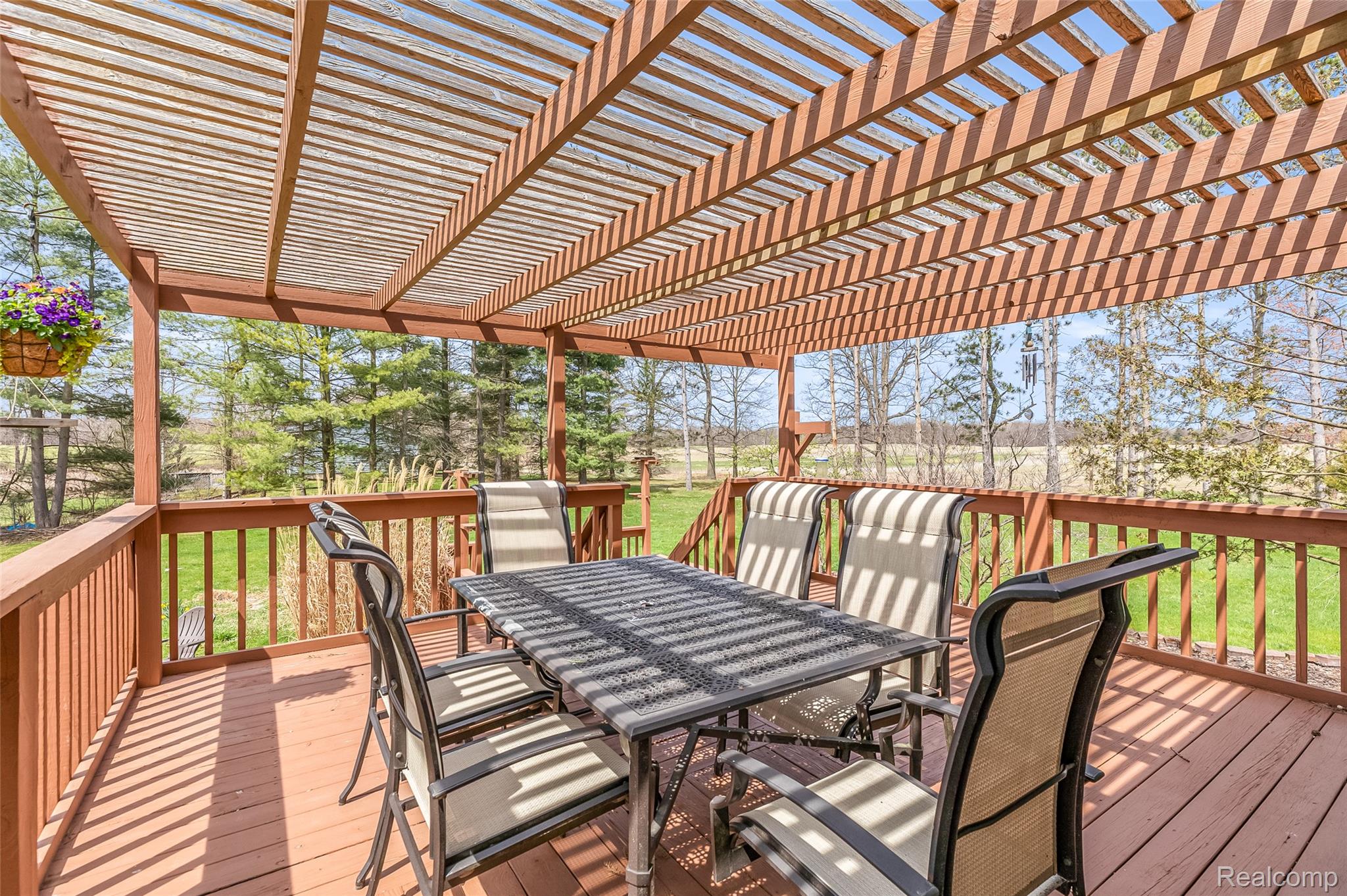 15395 Osius Road Chelsea, MI 48118 - Photo 38 of 55 Expansive wood-finish deck featuring a slatted pergola roof and a full railing system
