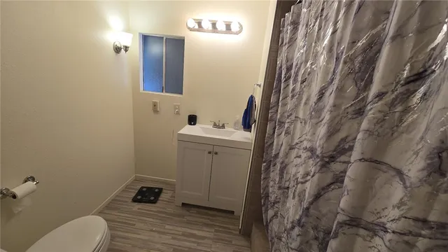 a bathroom with a sink toilet and mirror