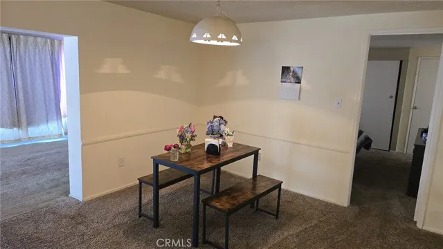 a view of a dining room with furniture and chandelier